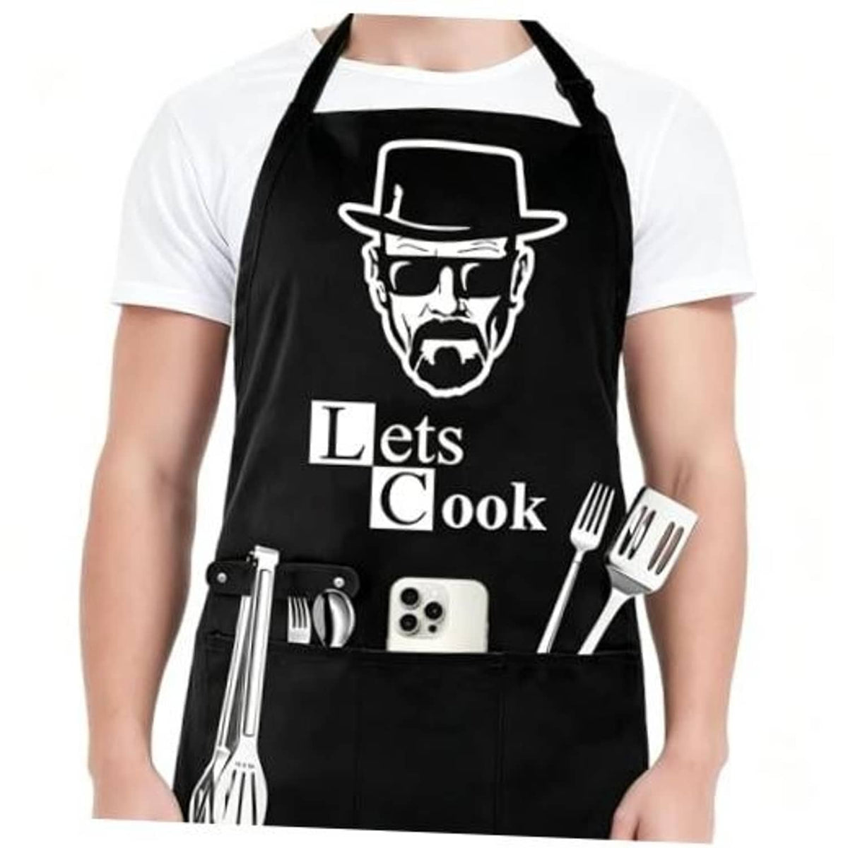 Black chef-style apron with 'Lets Cook' logo, adjustable straps and front pockets