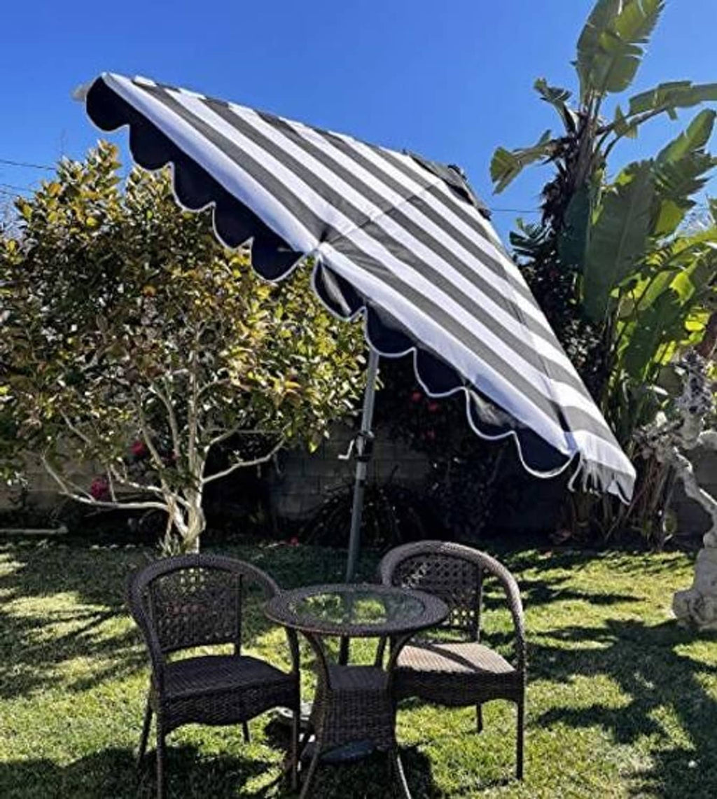 Black and white striped umbrella canopy with scalloped trim and valance
