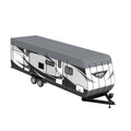 Grey RV roof cover fitted over a travel trailer, full-length coverage for protection.