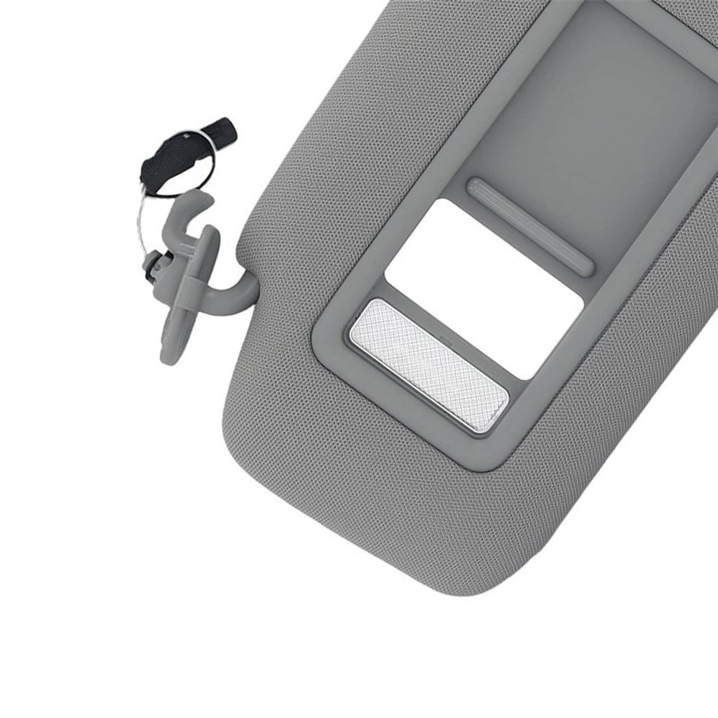 Gray sun visor with vanity mirror window and light strip detail on textured surface