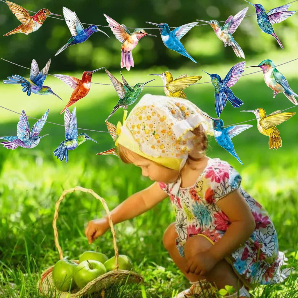 Colorful hummingbird string banner with multicolor bird cutouts hanging above child