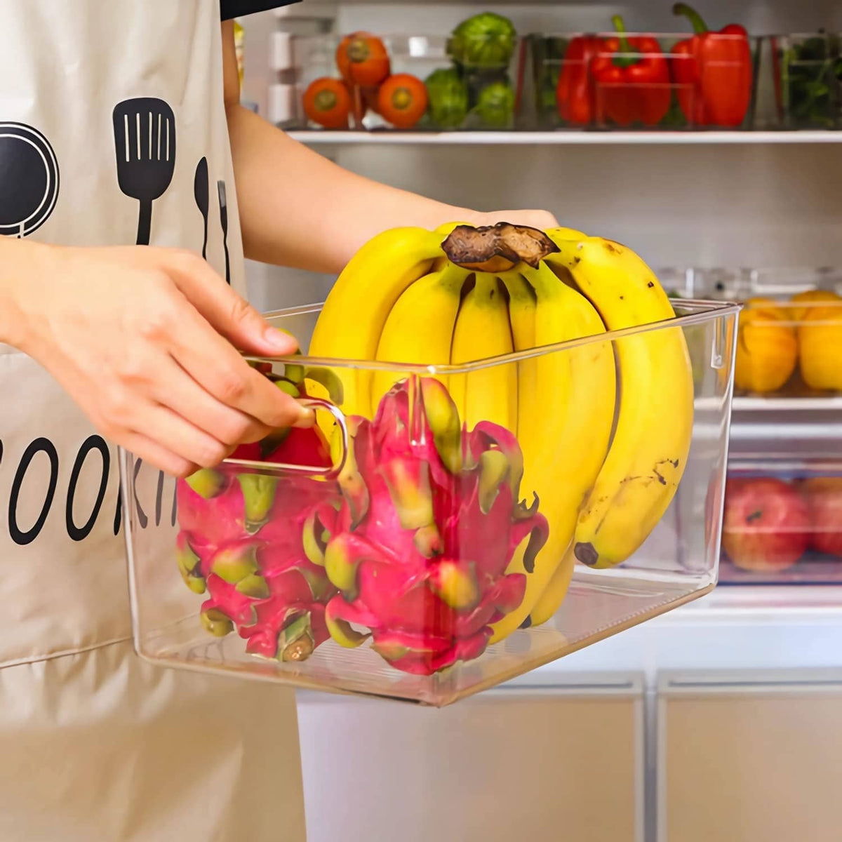 Clear plastic storage bin with handles, holding fruit and vegetables