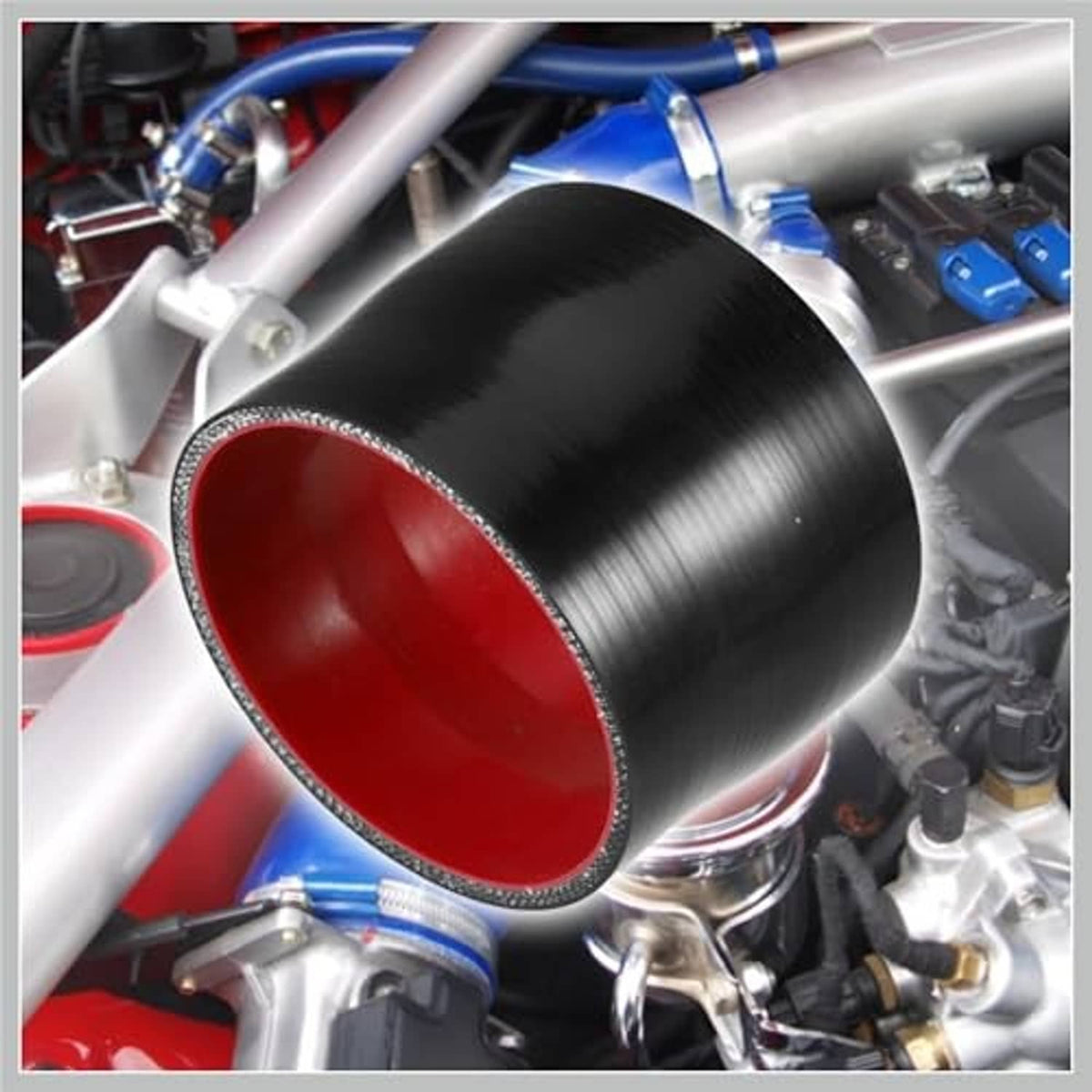 Silicone hose coupler installed on engine components, black body with red interior