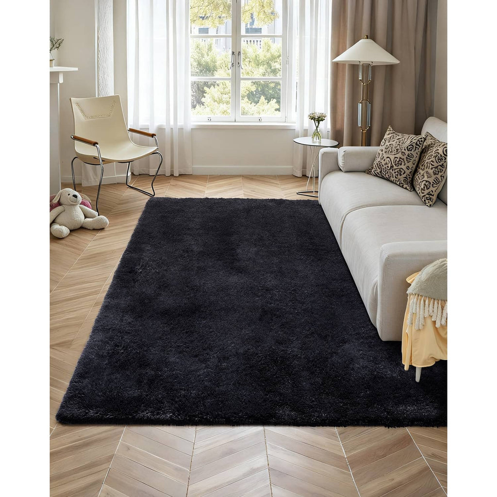 Black shag plush area rug on hardwood floor in a living room setting