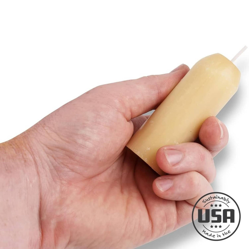 Natural beeswax candle held in hand, smooth yellow cylinder with wick
