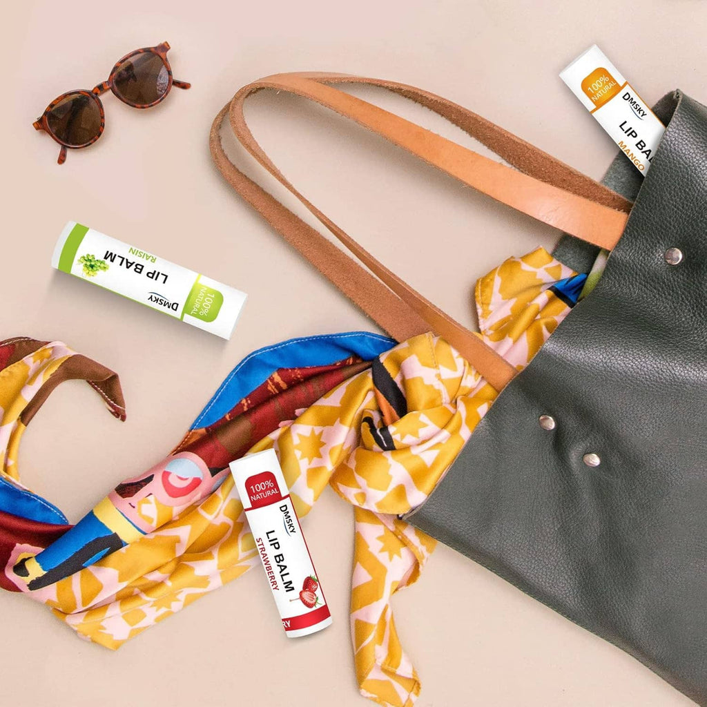 Lip balm tubes nestled in a patterned cloth bag with a couple extra tubes