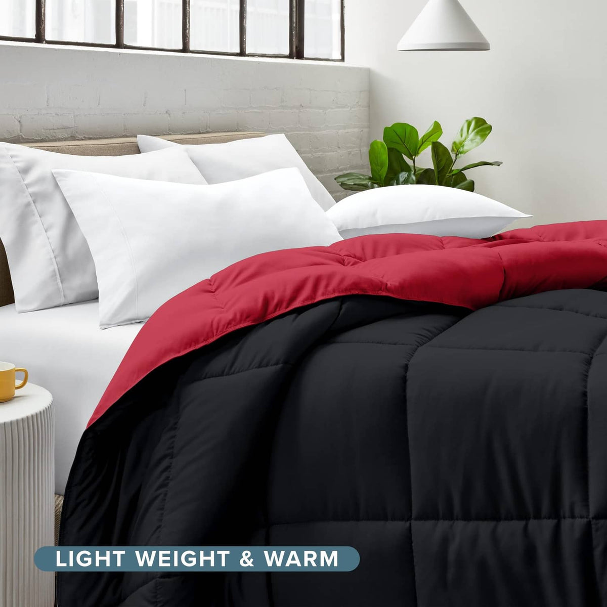 Reversible comforter on bed, red top over black bottom with box baffle stitching.