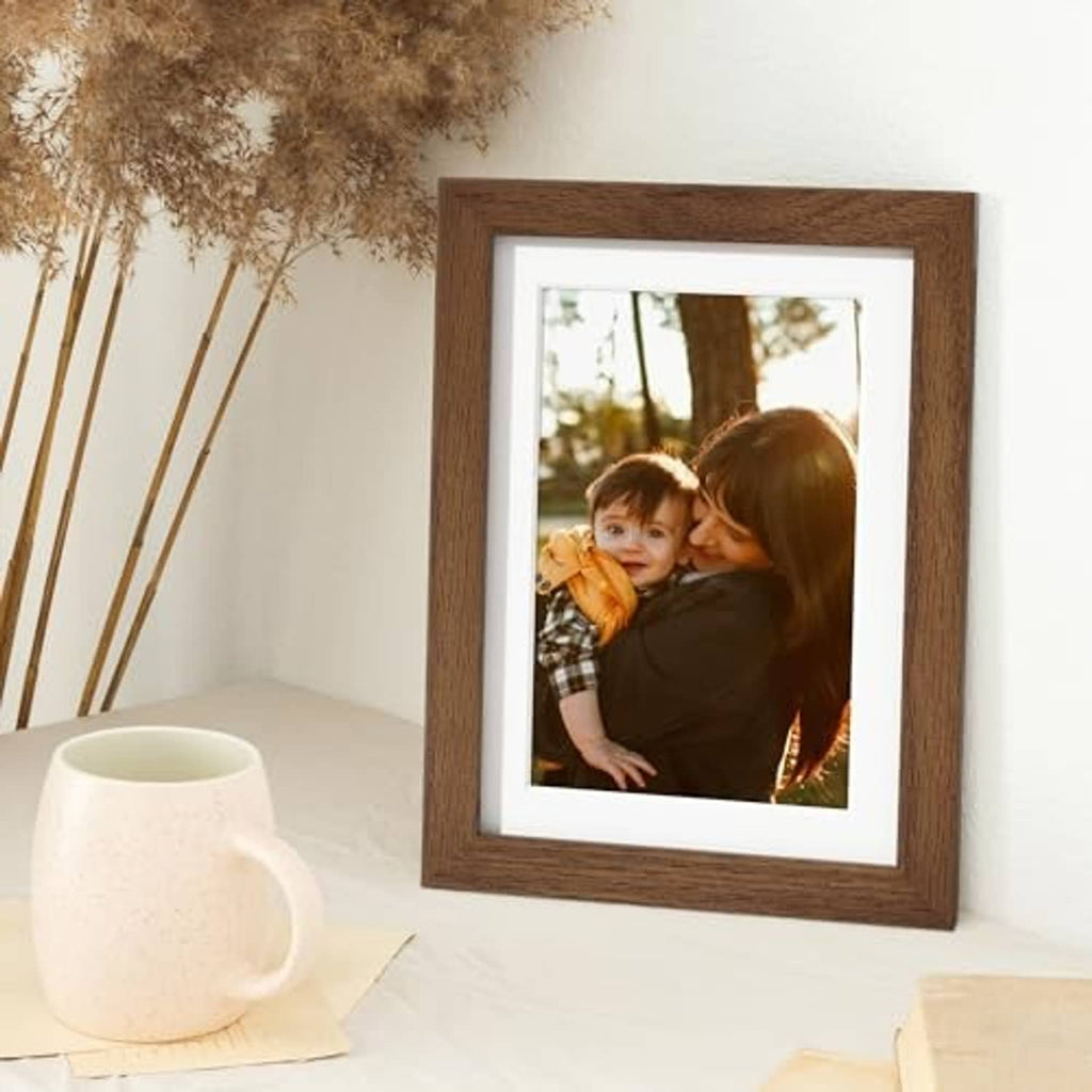 Oak wood picture frame with white mat, holding a photo of two people