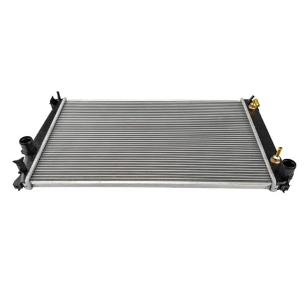 Auto radiator lying flat with silver fin core and visible inlet/outlet fittings.