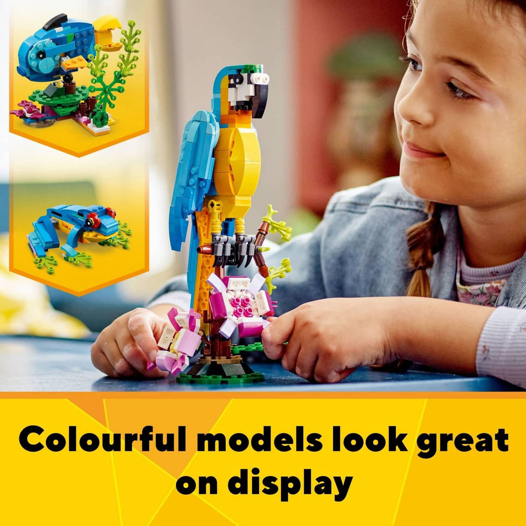 LEGO parrot build as a child assembles a blue and yellow bird with pink plants