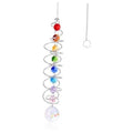 Hanging rainbow crystal wind spinner with spiral metal coil, colored beads, and prism ball.