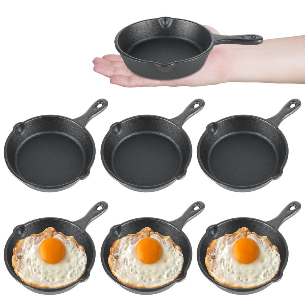 Set of 4-inch black mini cast iron skillets, one held in hand