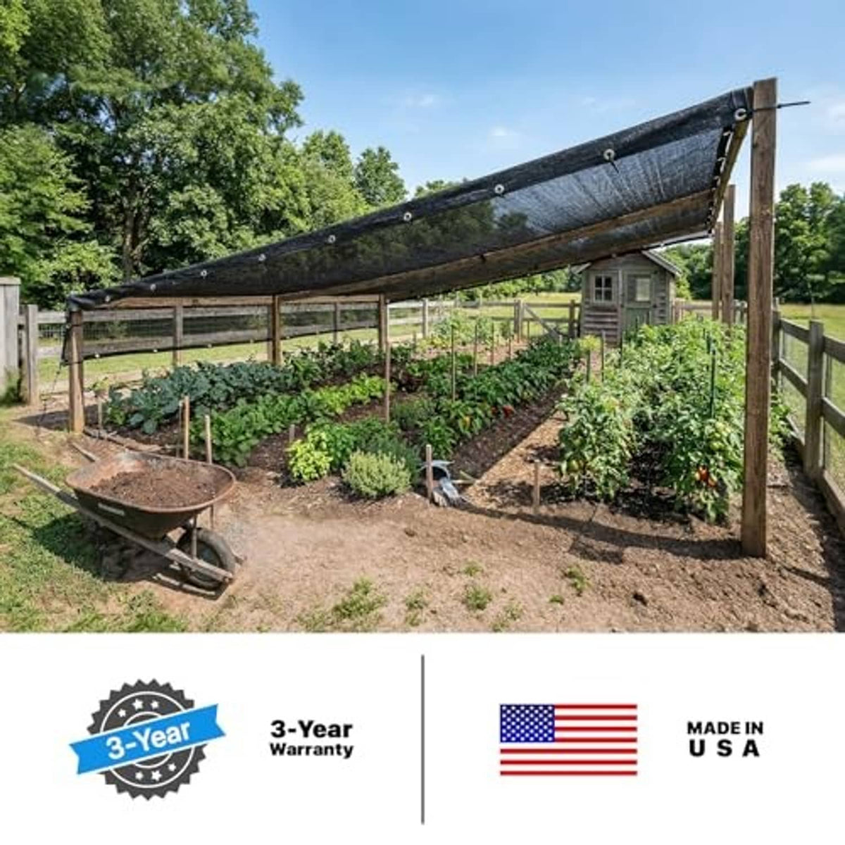 Black mesh shade tarp stretched over garden bed on wooden posts and ropes