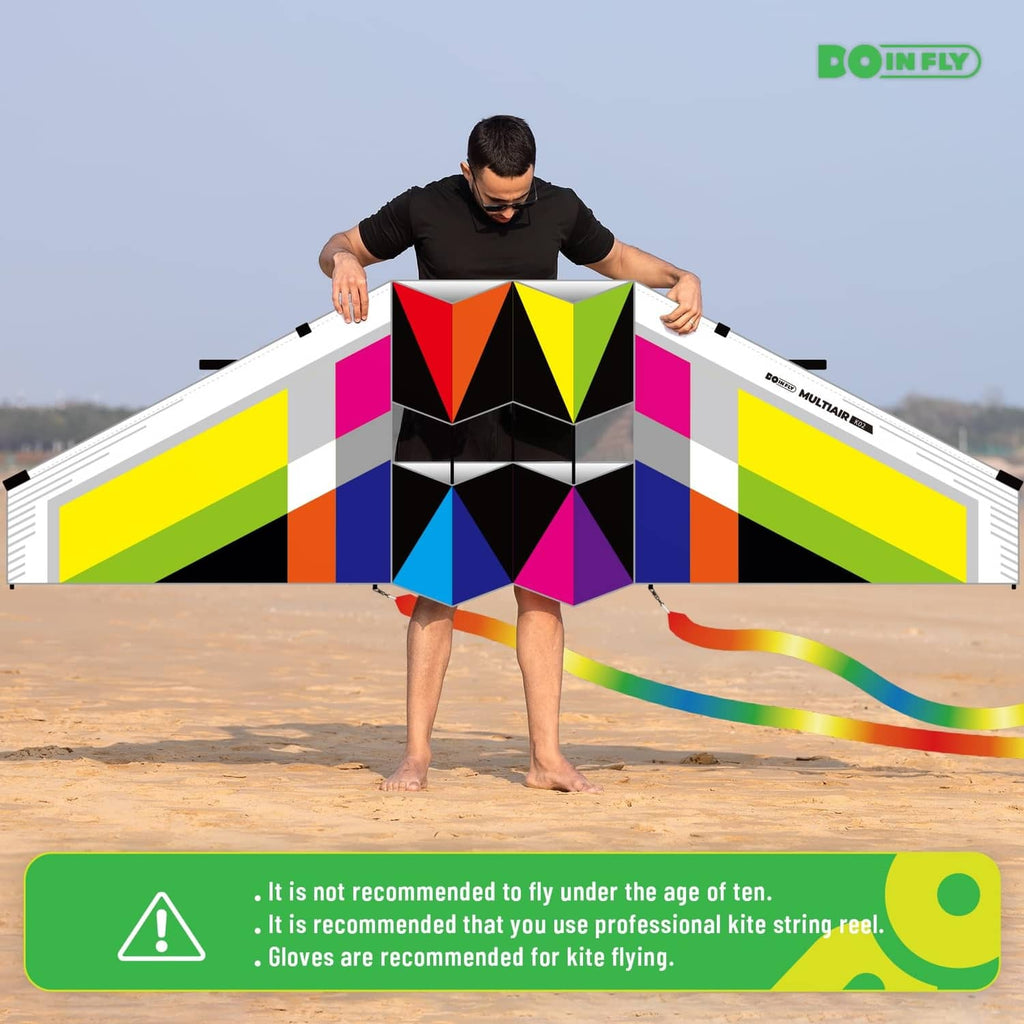 Triangular-shaped multicolor kite with geometric panel design and ribbon tail streamers