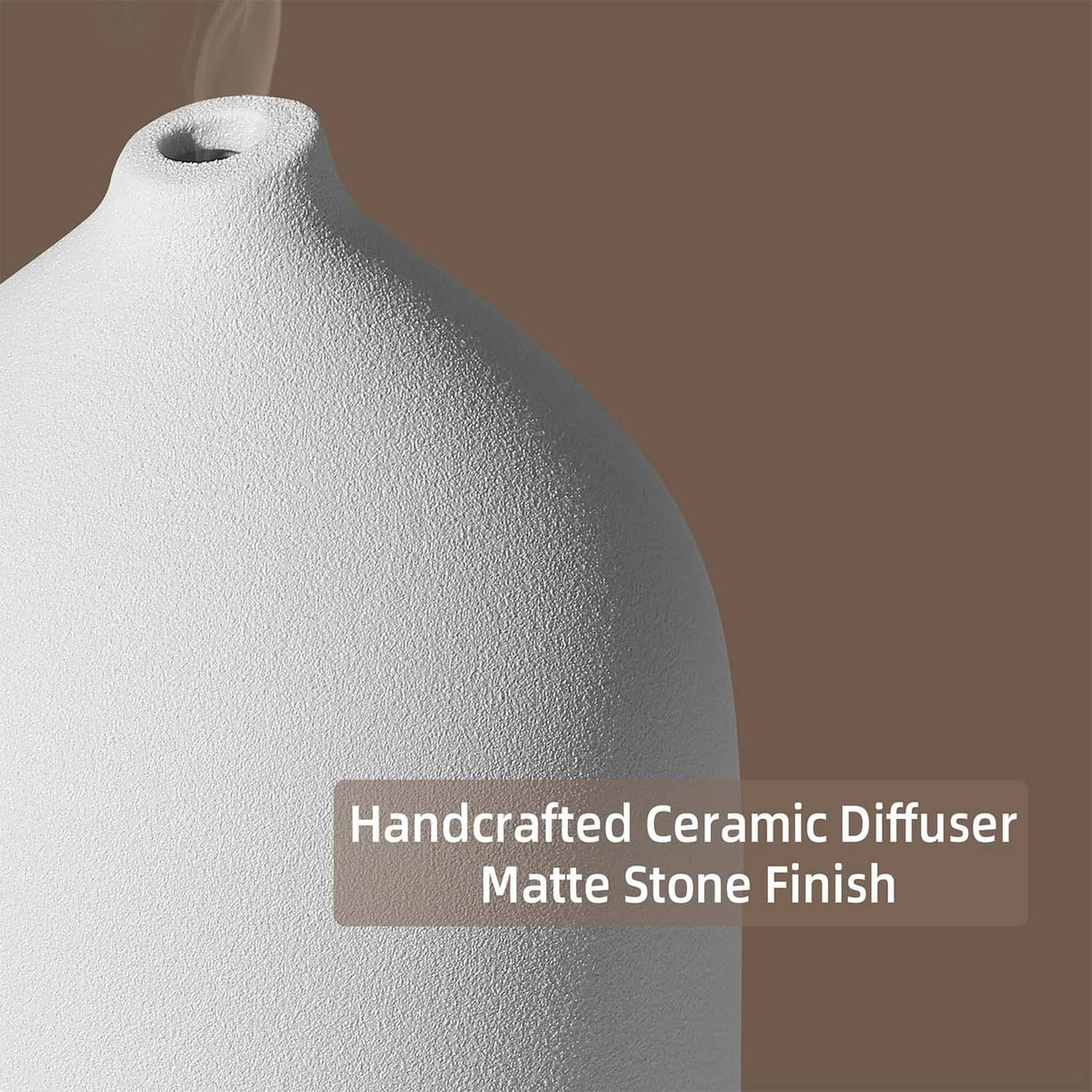 White ceramic essential oil diffuser with textured matte stone finish and open top.