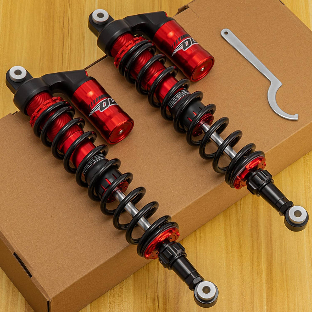 Set of four coil-over shocks in box: black springs with red reservoirs and chrome shafts