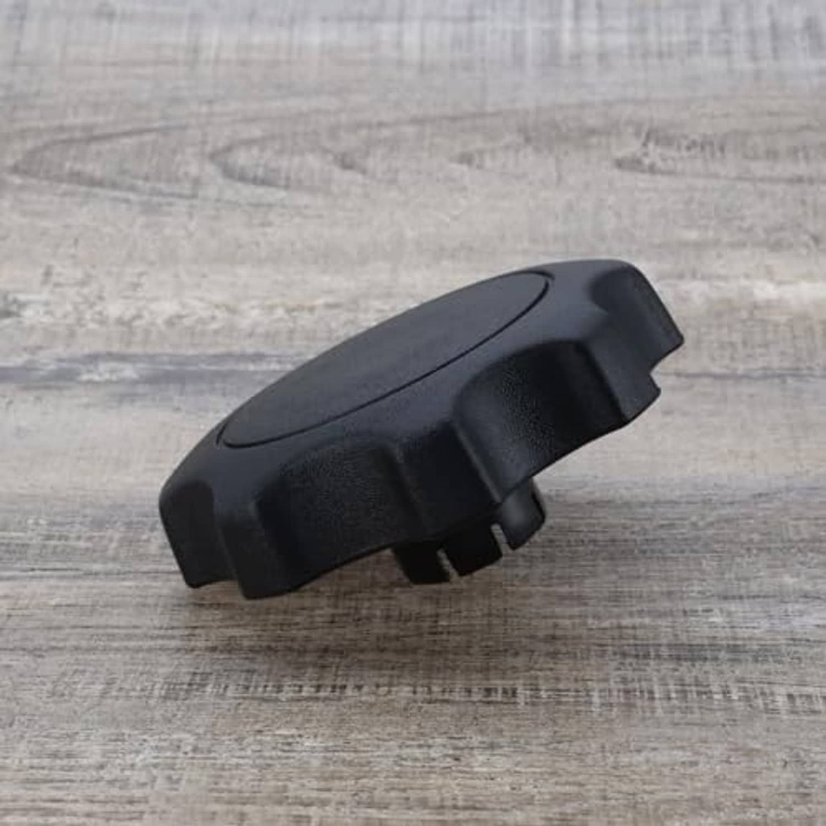 Black plastic car seat adjustment knob, low-profile side tab