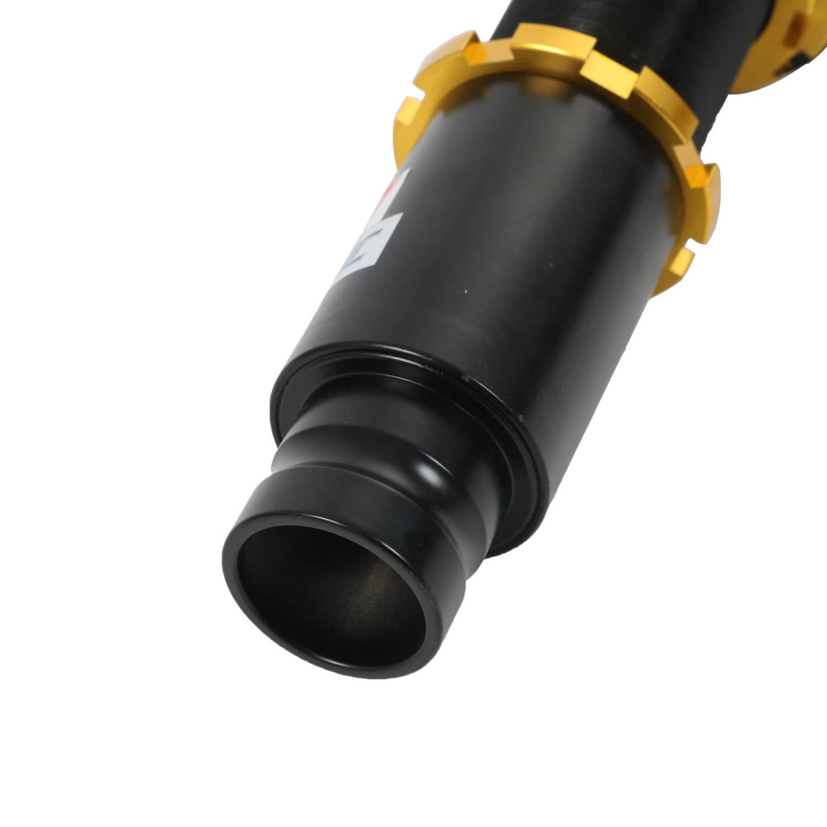Black shock cylinder end with gold collar on a coilover suspension strut