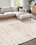 Beige large area rug with orange geometric tribal pattern on a flat woven surface