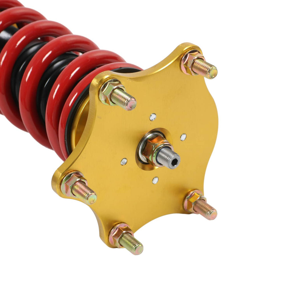 Red coil spring and gold top mount plate with multiple bolt points