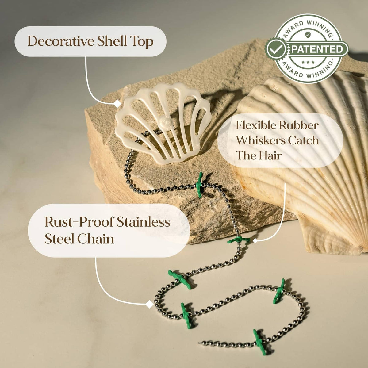 White shower drain hair catcher with decorative shell top, steel chain, green whiskers