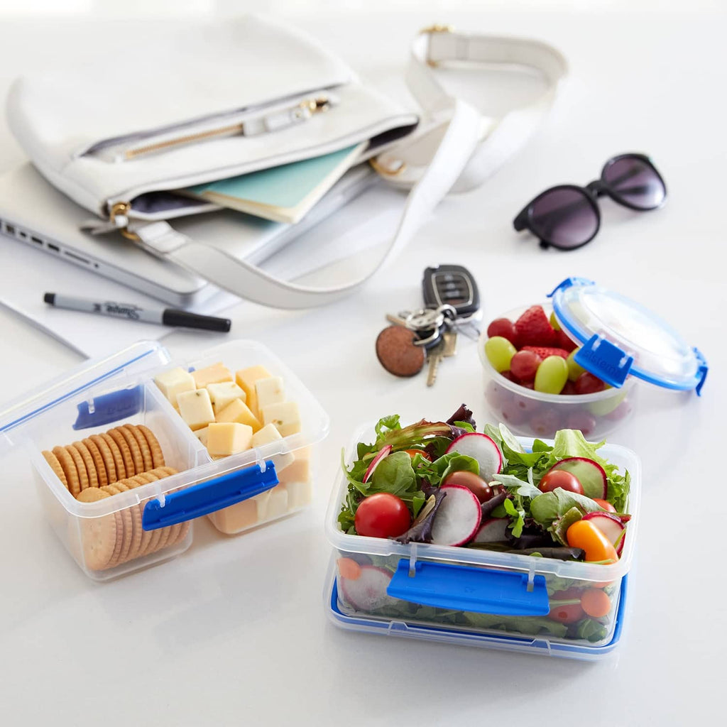Rectangular food storage containers with blue snap lids filled with assorted ingredients