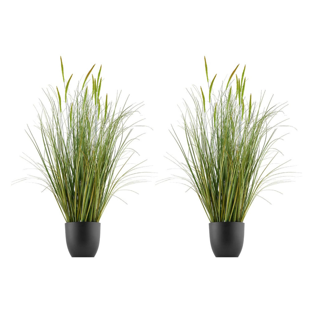Two potted artificial cattail grass plants with upright green blades in black pots