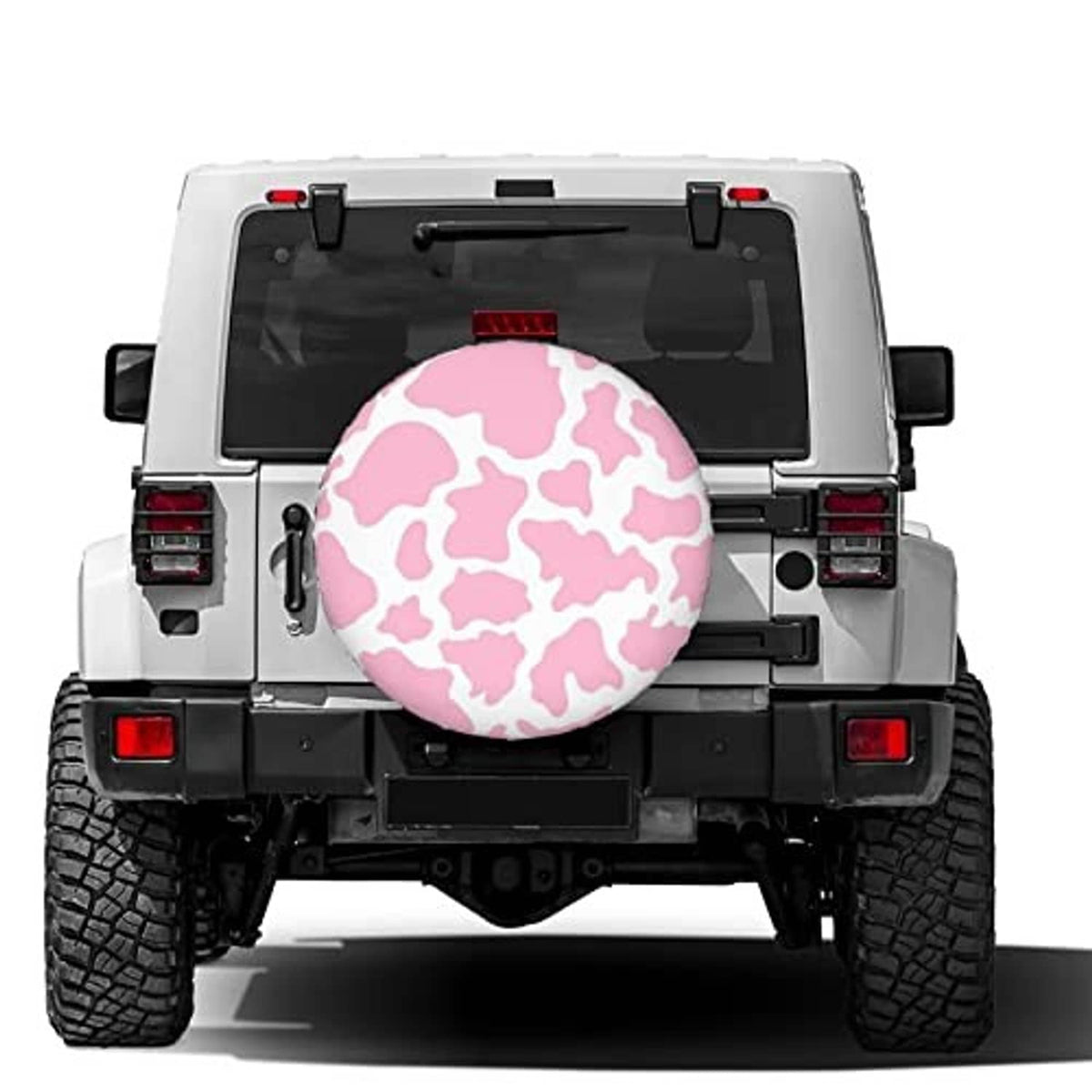 Pink cow-print spare tire cover on the back of a vehicle, round cover with black trim