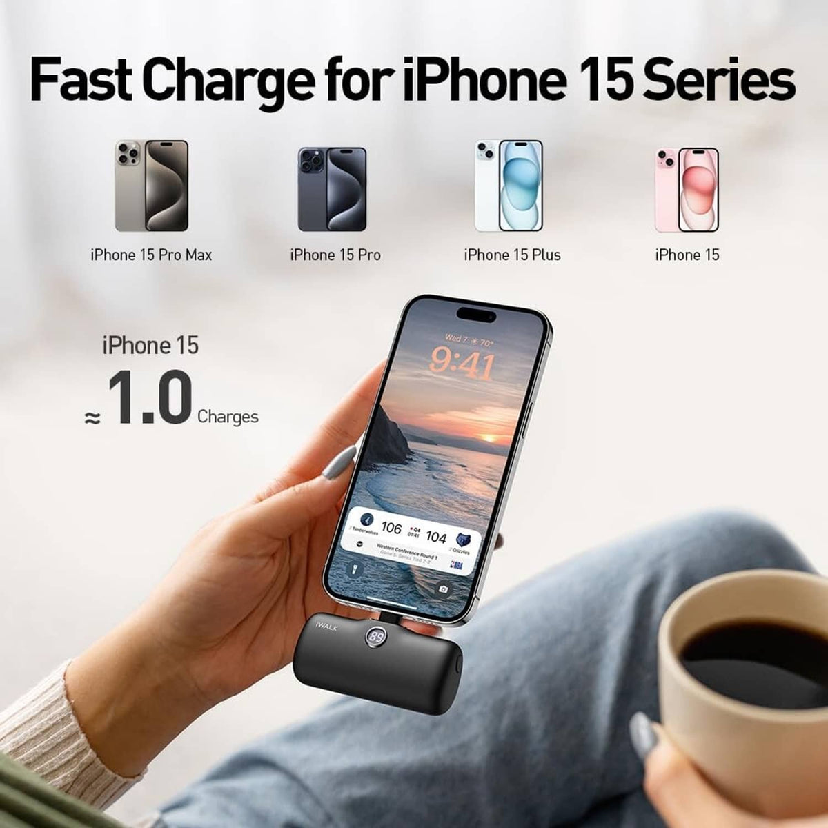 Black USB-C portable charger powering a smartphone; LED display visible