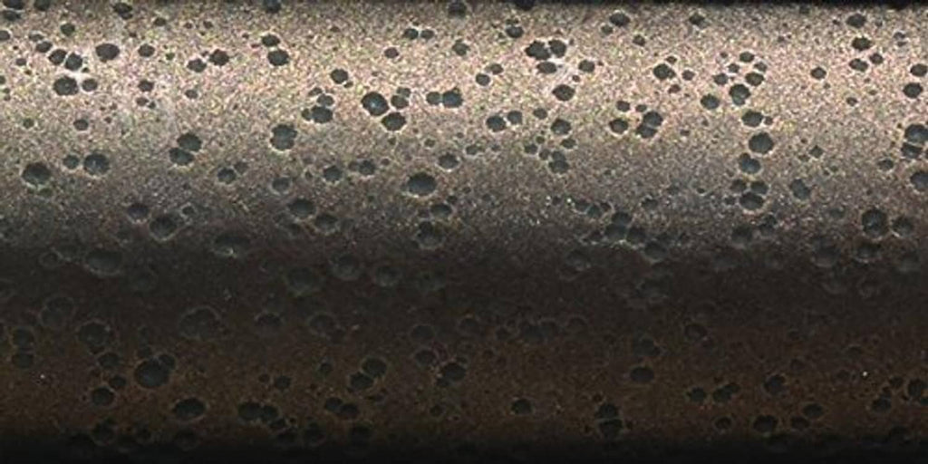 Brown speckled metal pole surface close-up