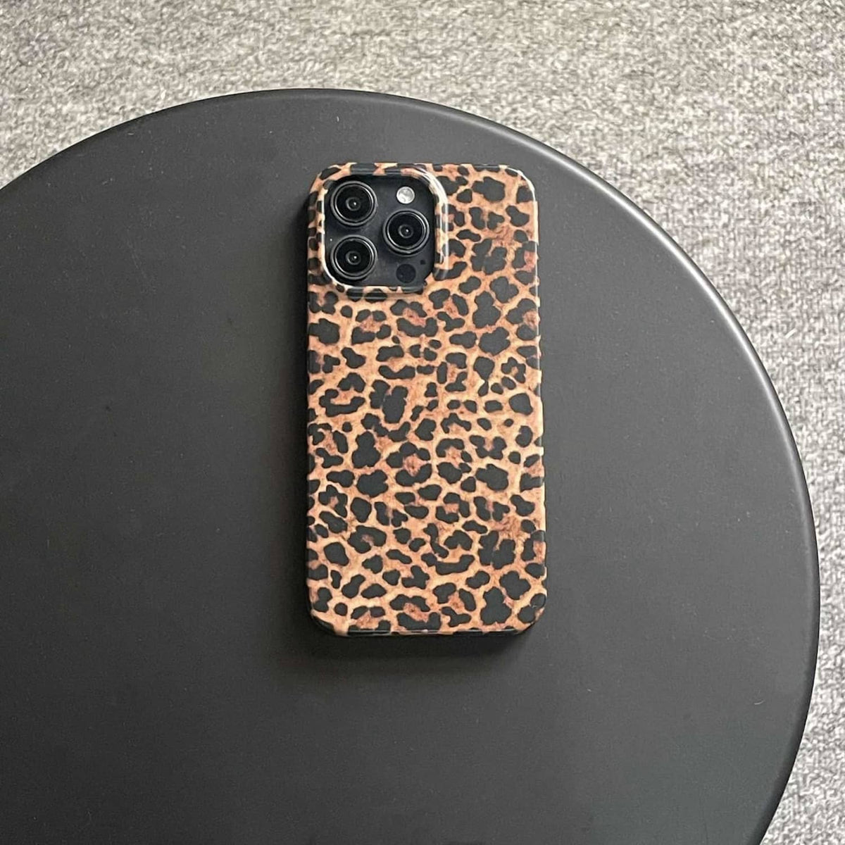 Brown leopard print phone case, back view with four-lens camera openings