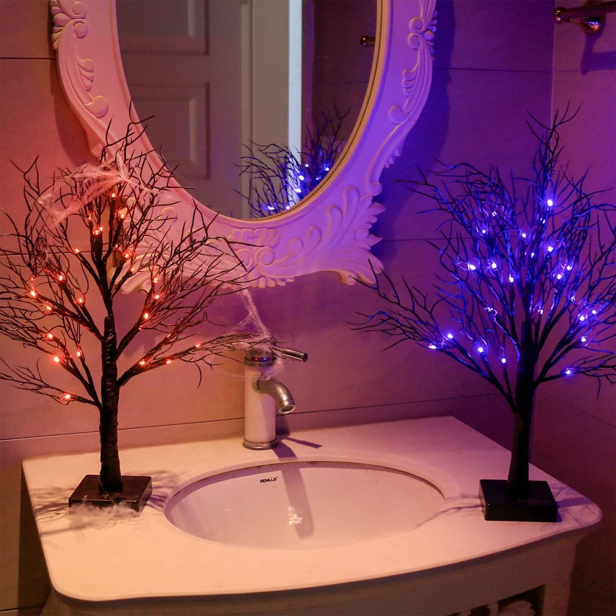 Halloween light trees on sink counter, purple and orange glowing branches