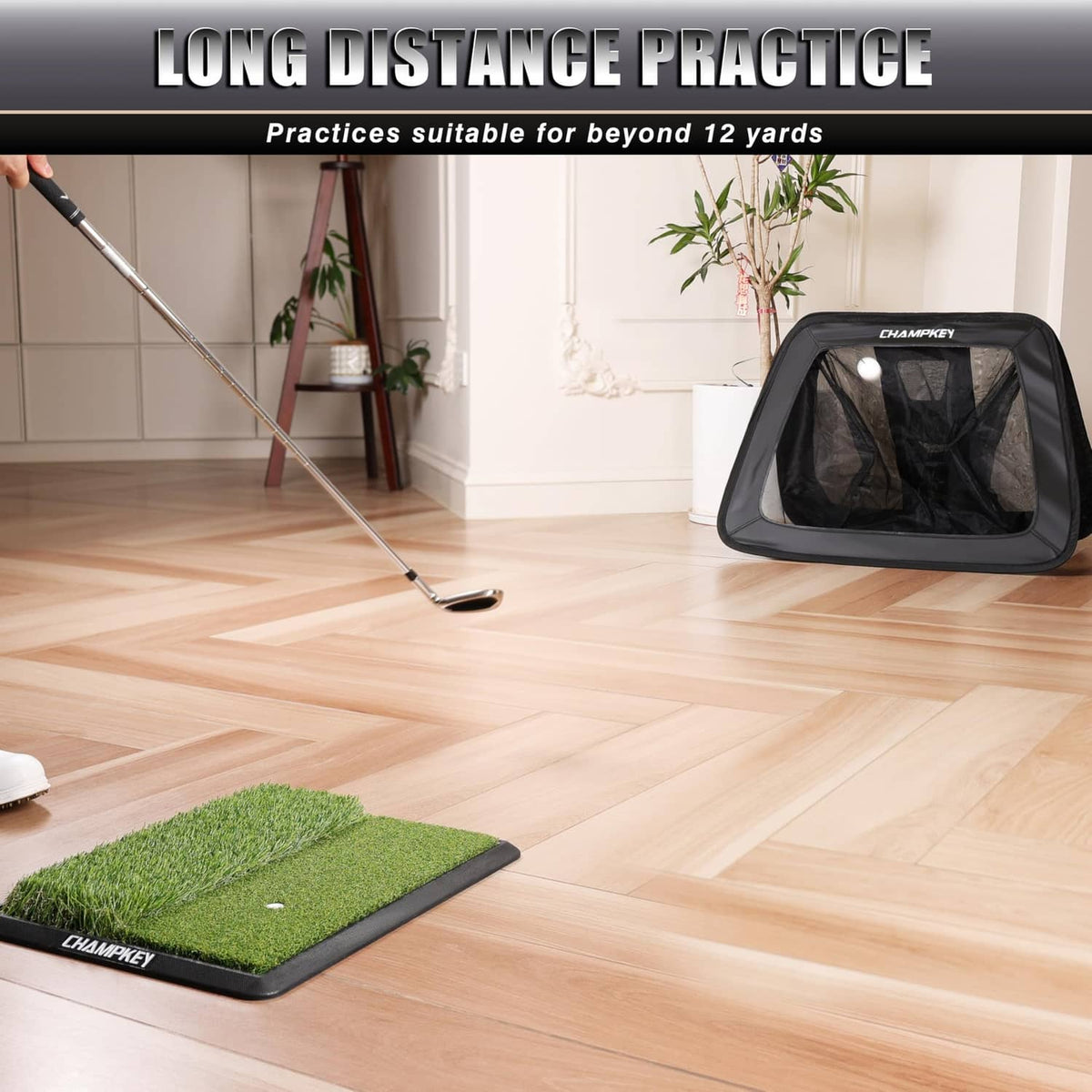 Black golf chipping net for long-distance practice with practice mat on floor