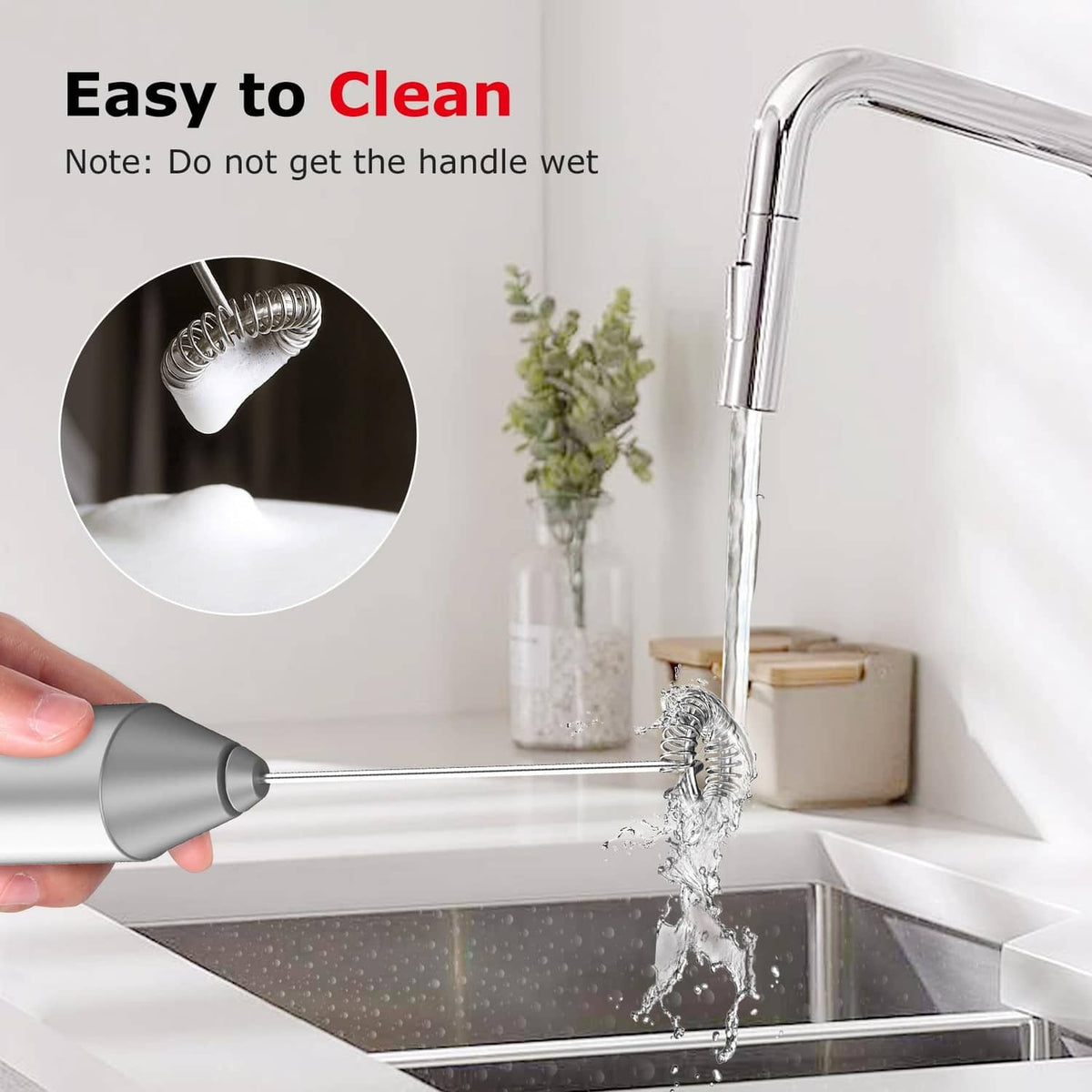Silver milk frother rinsed under running water at the sink