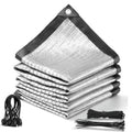 Silver aluminet shade cloth folded and stacked with black edging, grommets, and ties