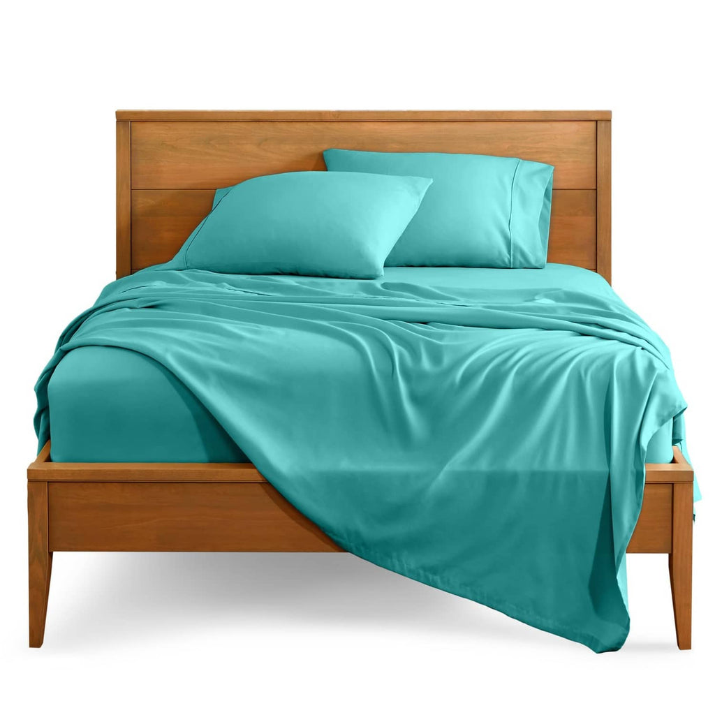 Turquoise twin bed sheet set with pillowcases and fitted sheet over a flat sheet