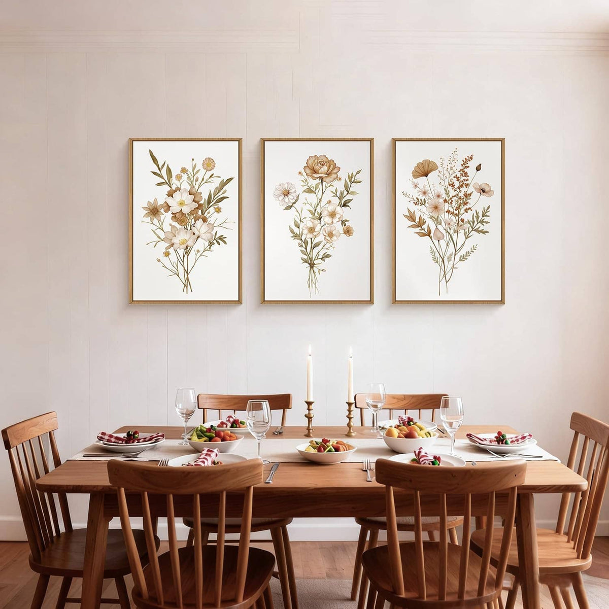 Three framed botanical flower canvas prints with gold frames on wall