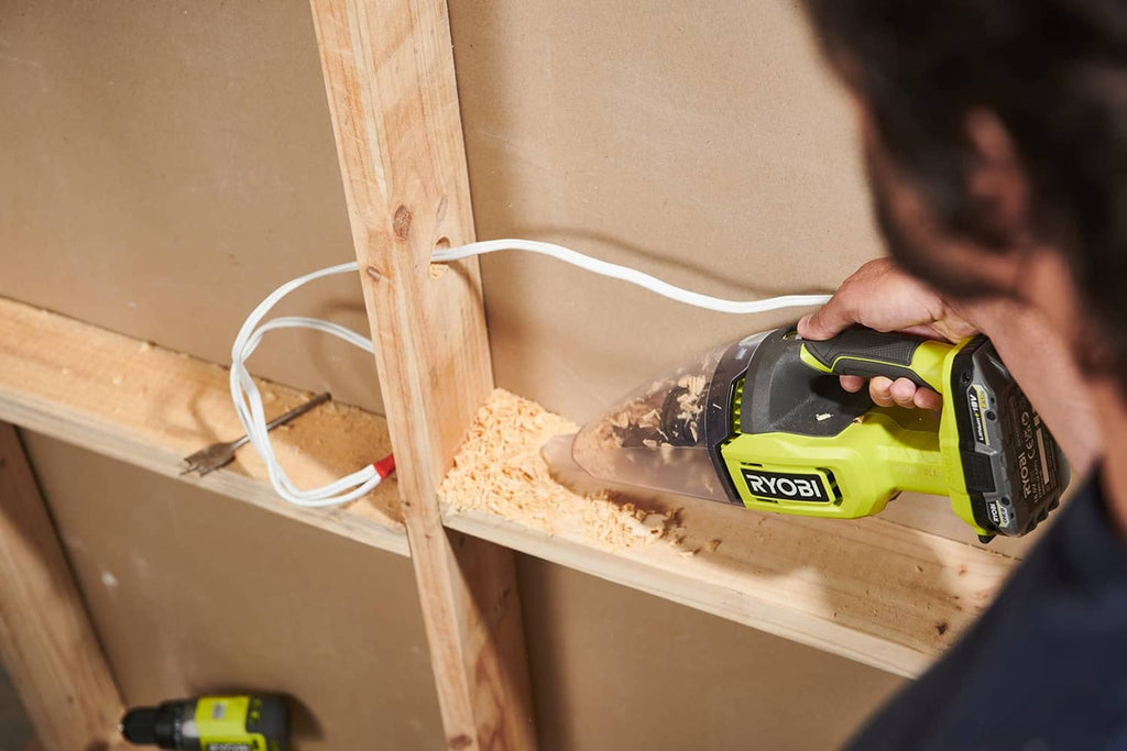 Handheld vacuum cleaner in lime green and black, compact nozzle for dust pickup