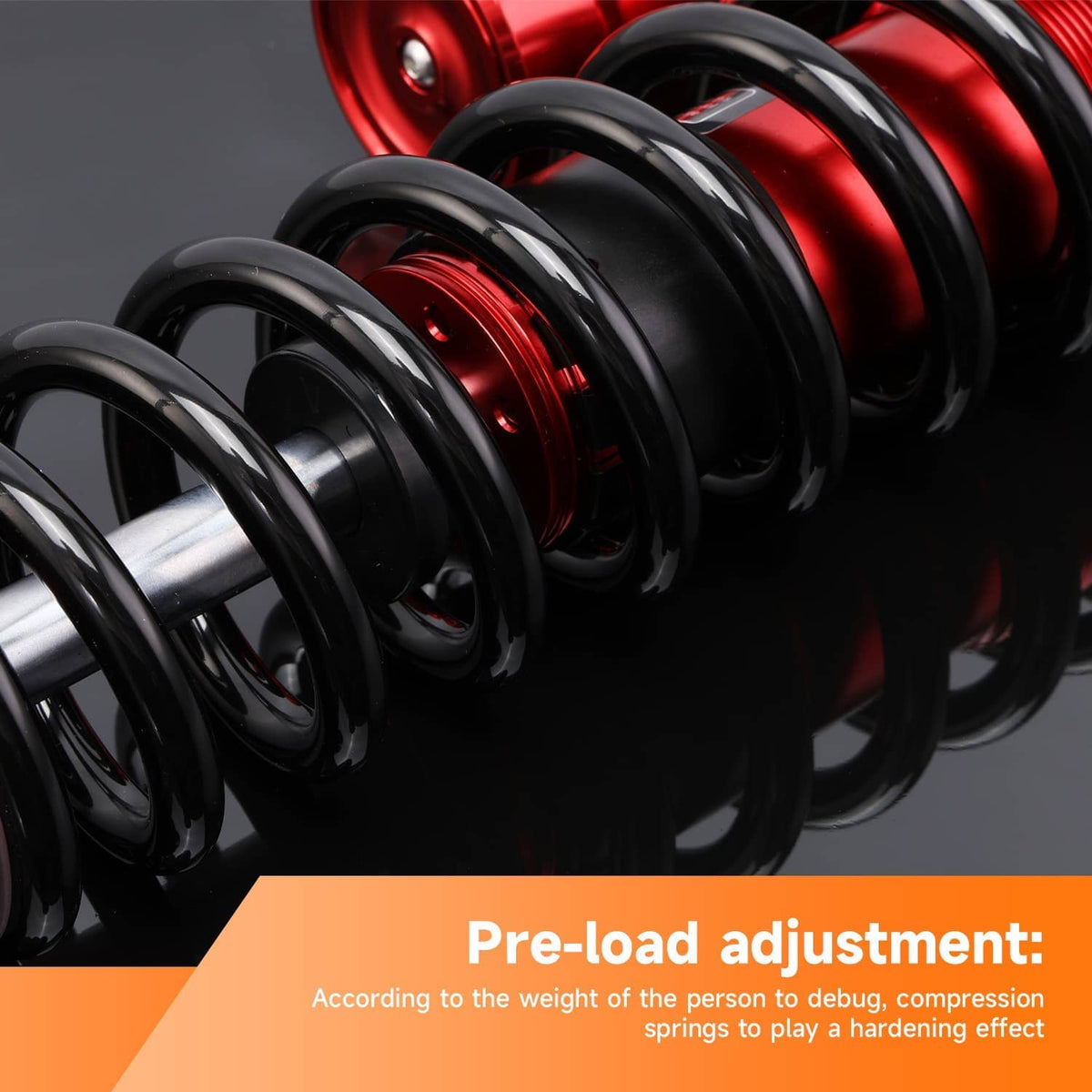 Close-up of black coil spring wrapped around a red shock cylinder