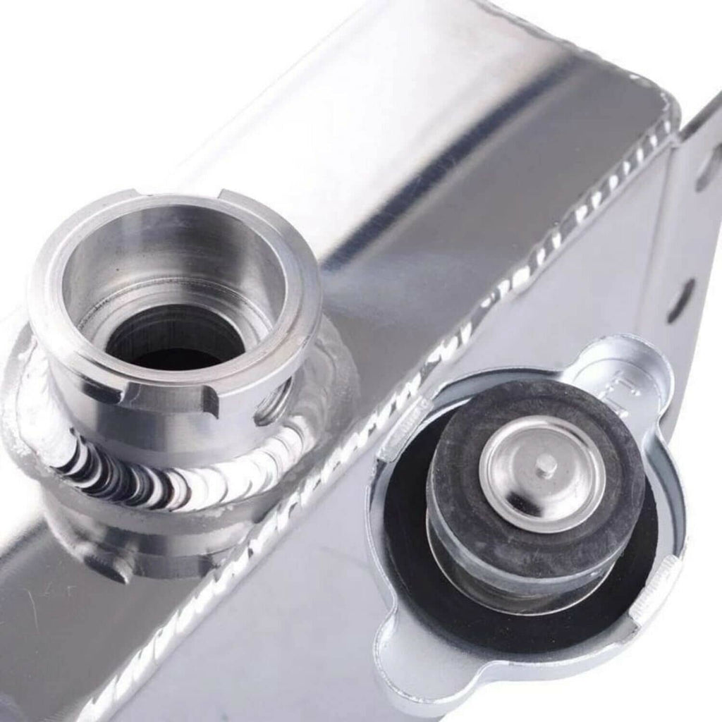 Aluminum coolant reservoir with side ports, cap opening, and rubber grommet
