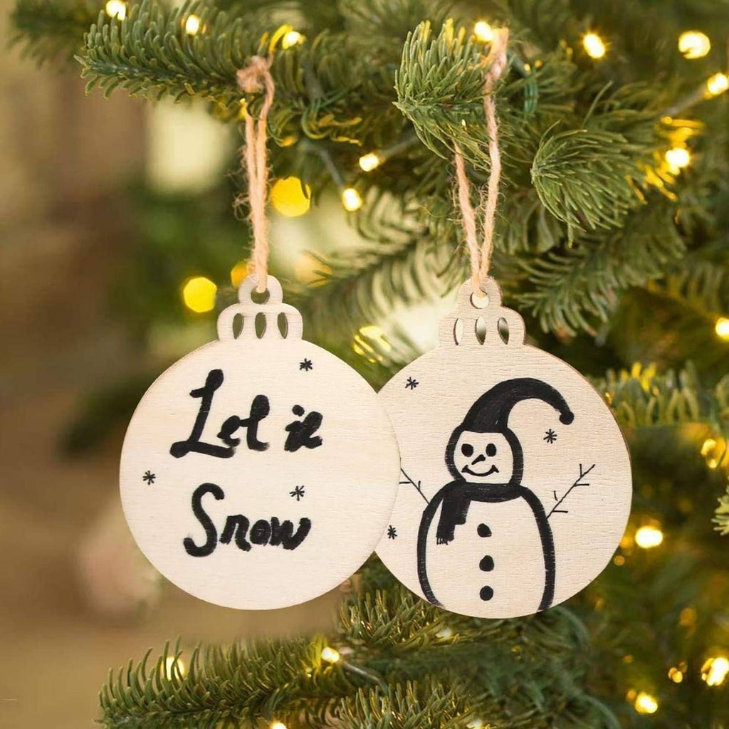 Painted round wooden Christmas ornaments on a tree: 'Let it Snow' and snowman