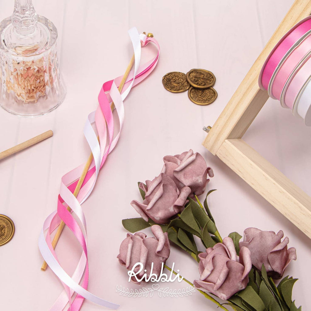 Spiral pink ribbon and ribbon-wrapped roses with wooden cutting board and coins