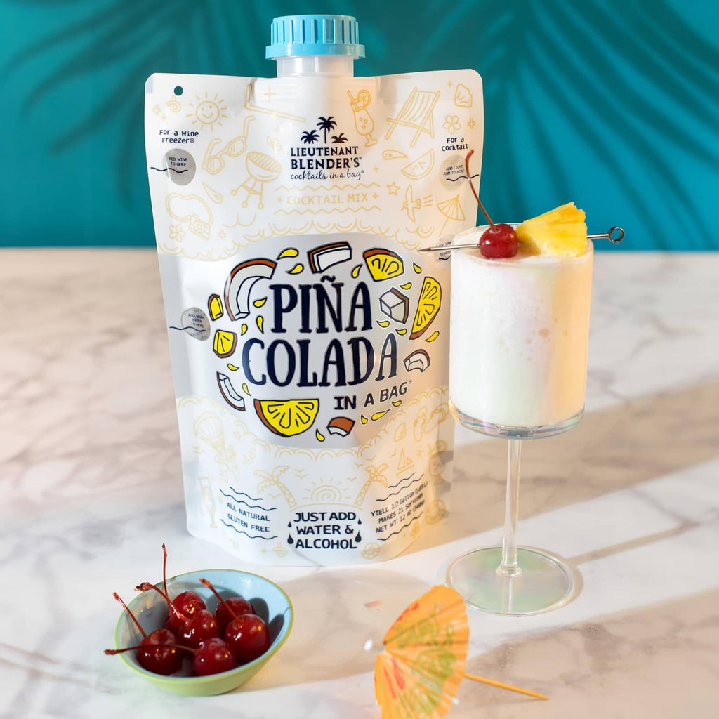 Pina colada cocktail mix pouch with coconut-pineapple garnish and pale-yellow drink