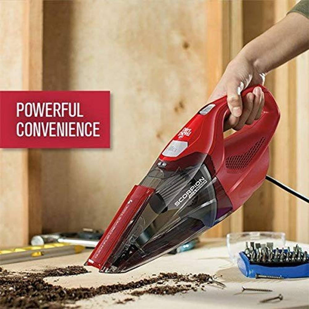 Red Dirt Devil Scorpion Plus handheld vacuum held over carpet with debris