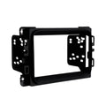Matte black double-DIN dash kit bezel with mounting brackets and openings