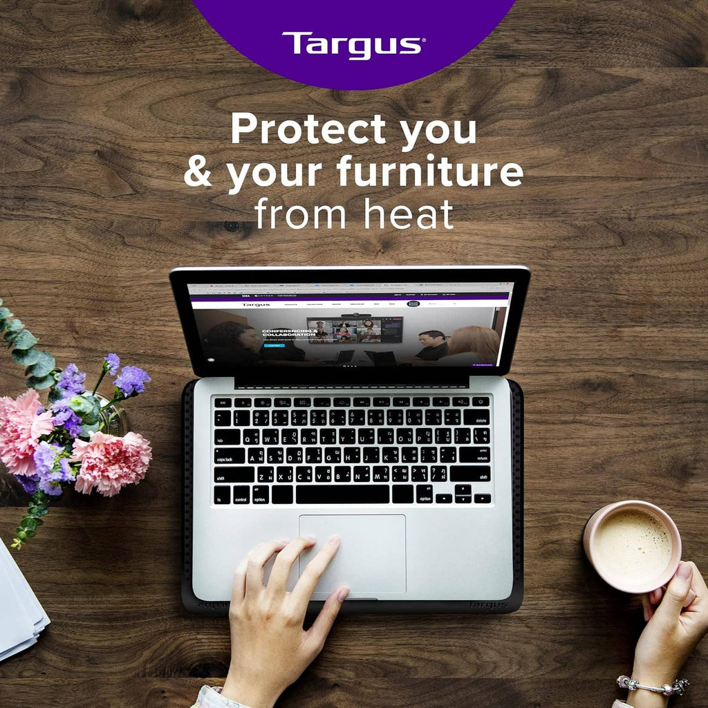 Black cooling laptop mat under an open laptop on a desk surface.