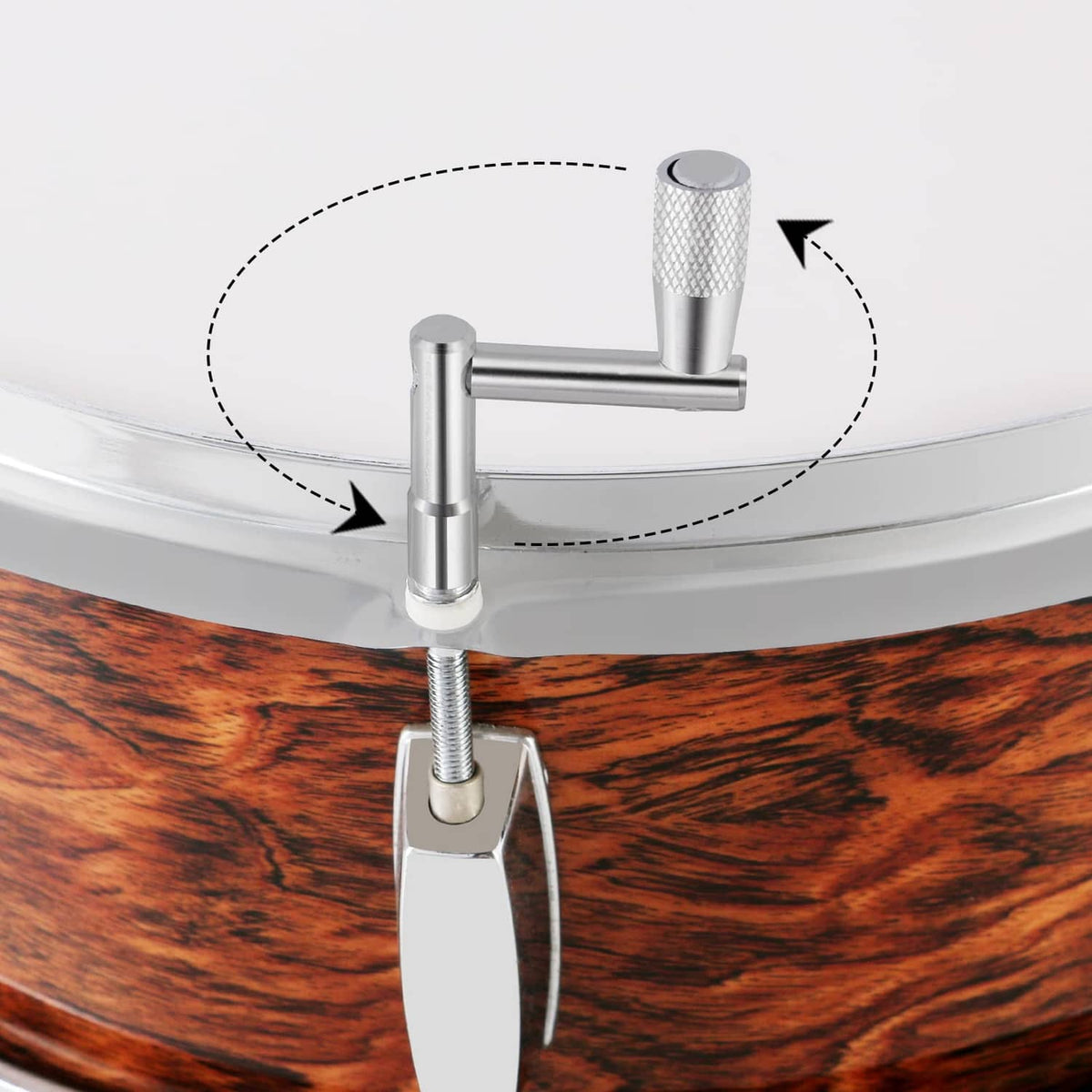 Drum tuning key and bit set inserted into drum hoop for adjustments