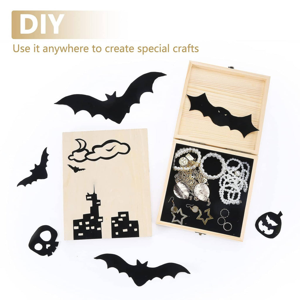 Black self-adhesive sheet for DIY crafts, with cut bat shapes on wood