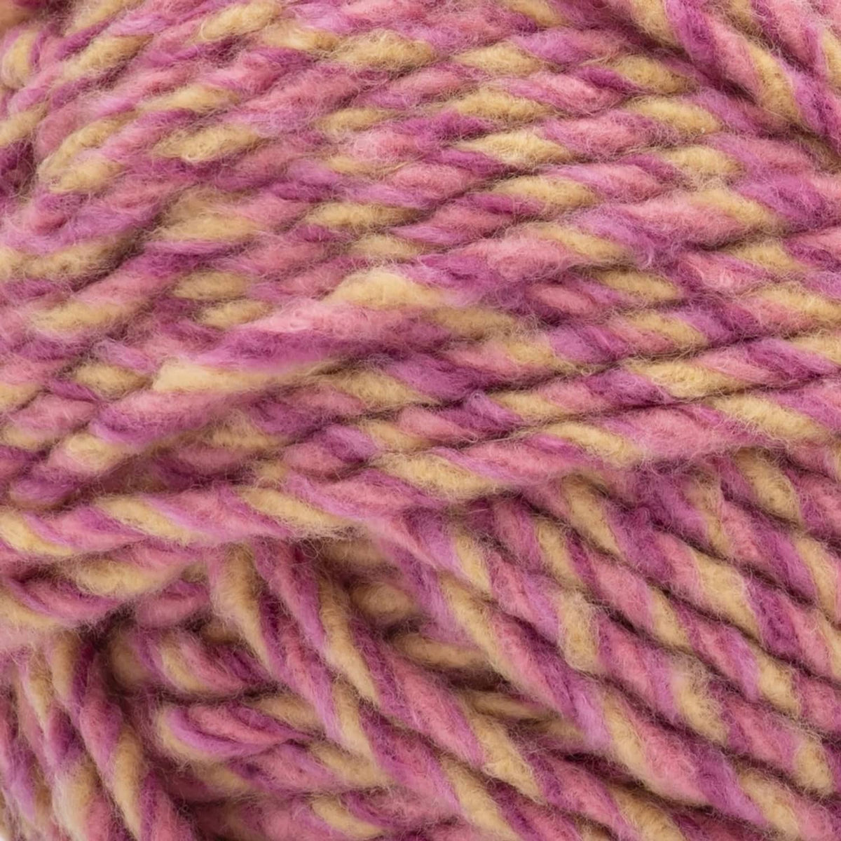 Super bulky fleece yarn close-up in pink, purple, and yellow heather texture