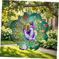 Green butterfly wind spinner hanging in a garden, purple butterfly with swirl rings